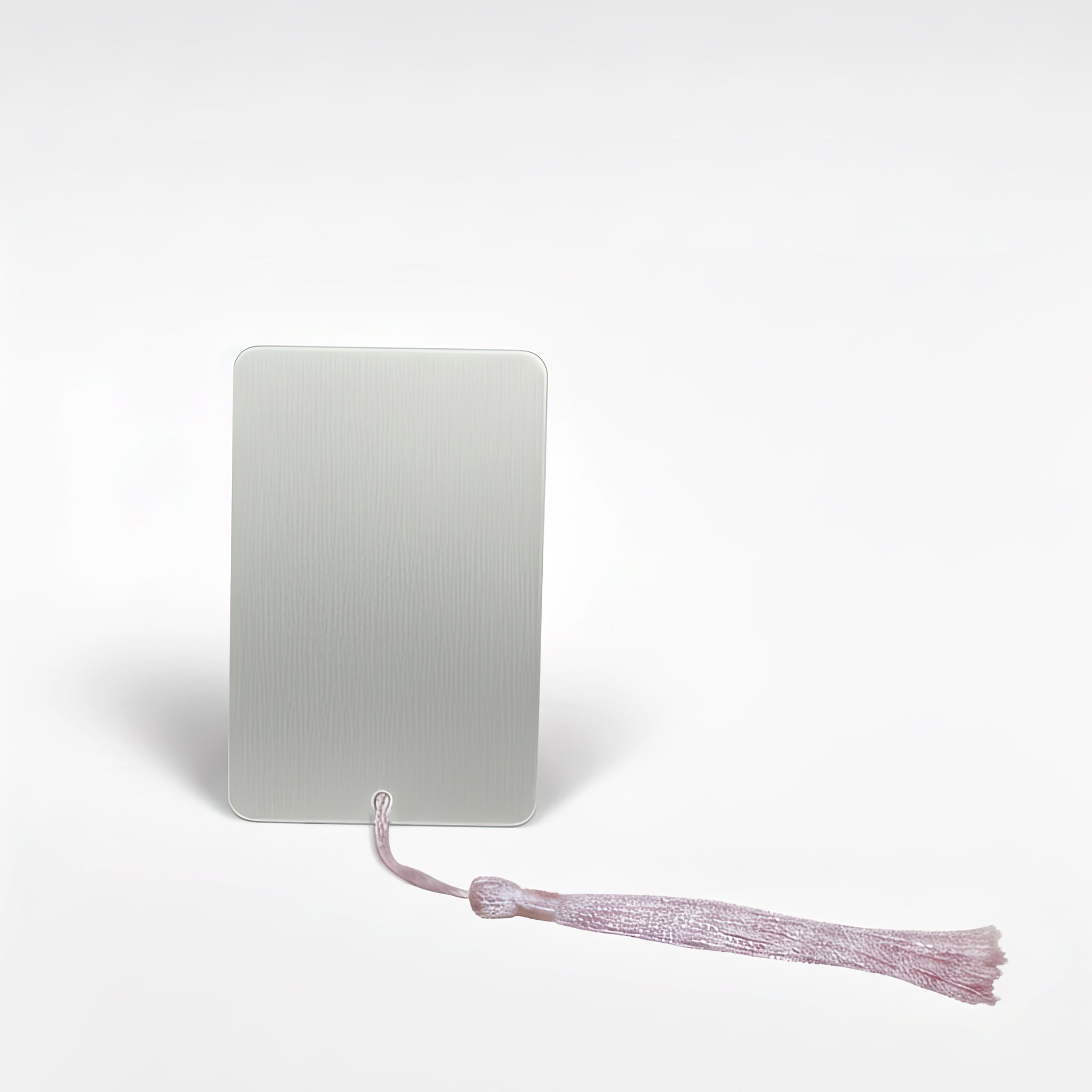 Plain silver back view of a personalised romantasy metal bookmark with subtle brushed texture and pink tassel, handmade in the UK.