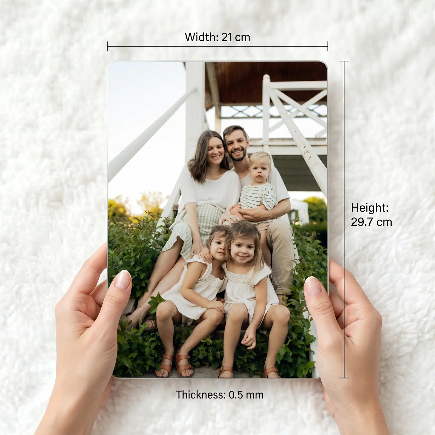 A4 personalised metal photo panel held for scale showing dimensions 21cm x 29.7cm and 0.5mm thickness