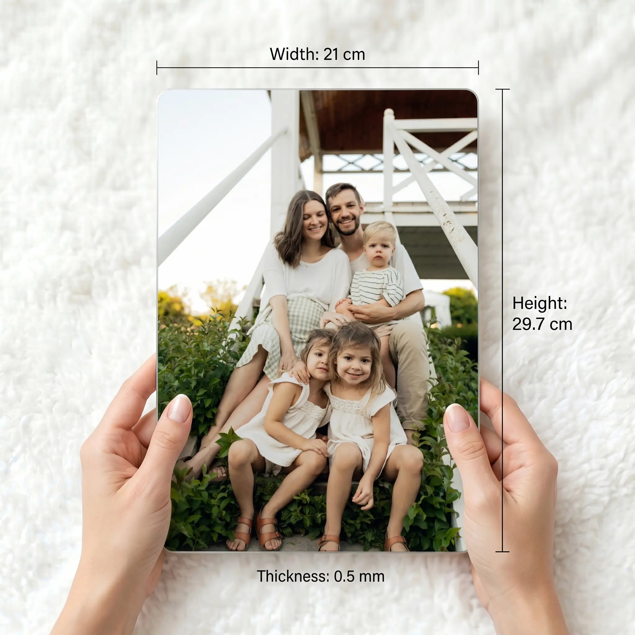A4 personalised metal photo panel held for scale showing dimensions 21cm x 29.7cm and 0.5mm thickness