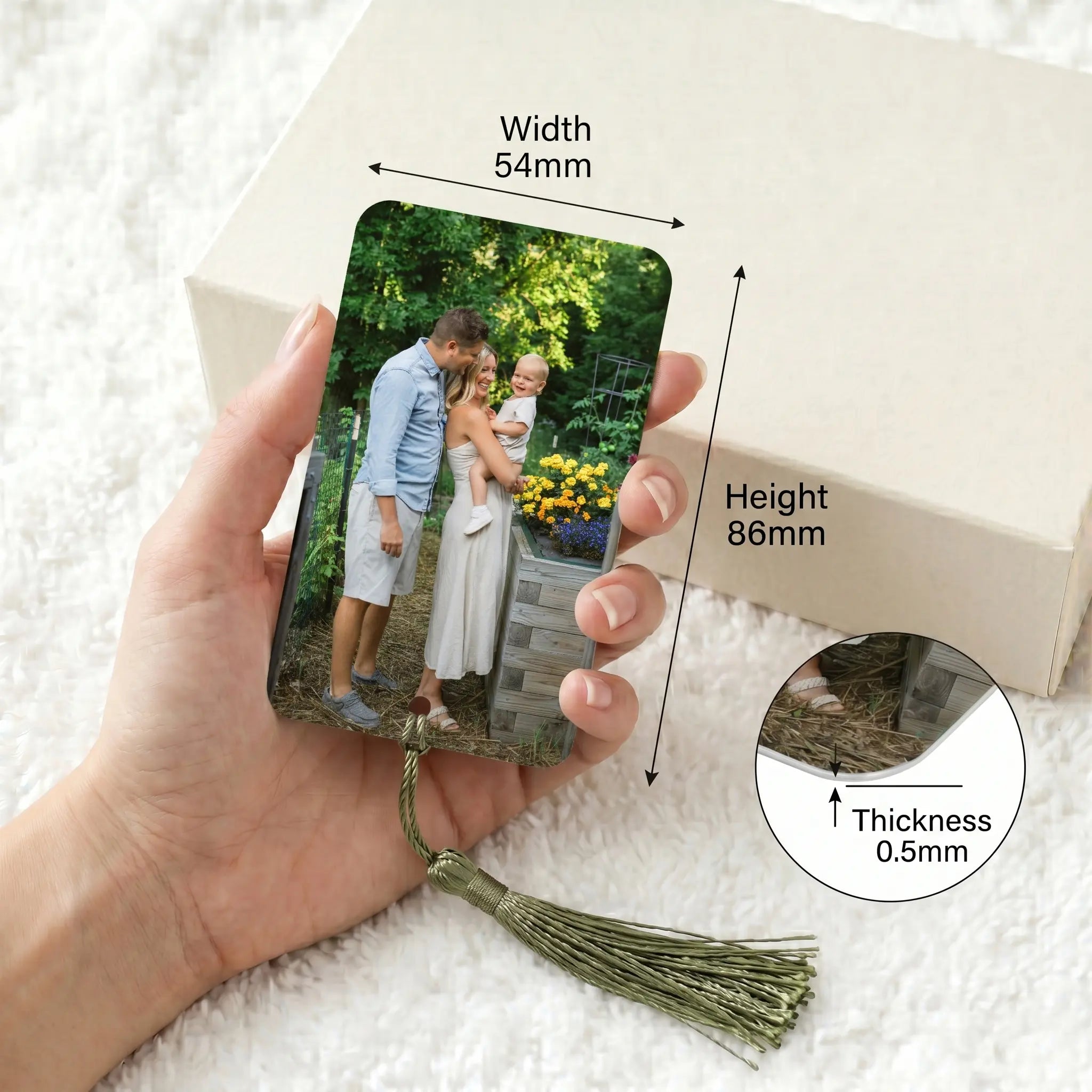 Personalised aluminium photo bookmark held in hand showing dimensions and slim 0.5mm thickness