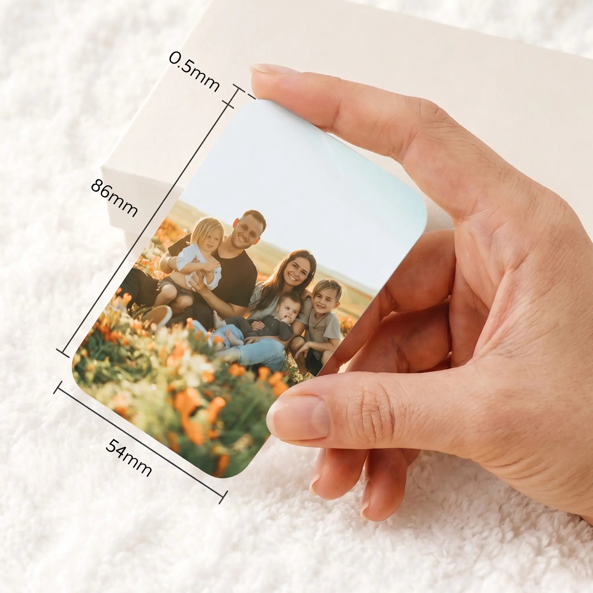 Personalised metal wallet card held in hand, showing standard bank card size dimensions