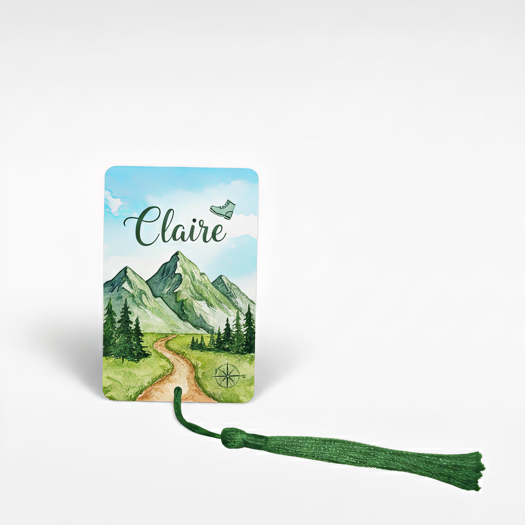 Personalised mountain adventure bookmark with green tassel – custom name “Claire” printed on a scenic hiking trail design, featuring hand-painted mountains, trees and compass. Unique gift for book lovers and outdoor enthusiasts, handmade in the UK.