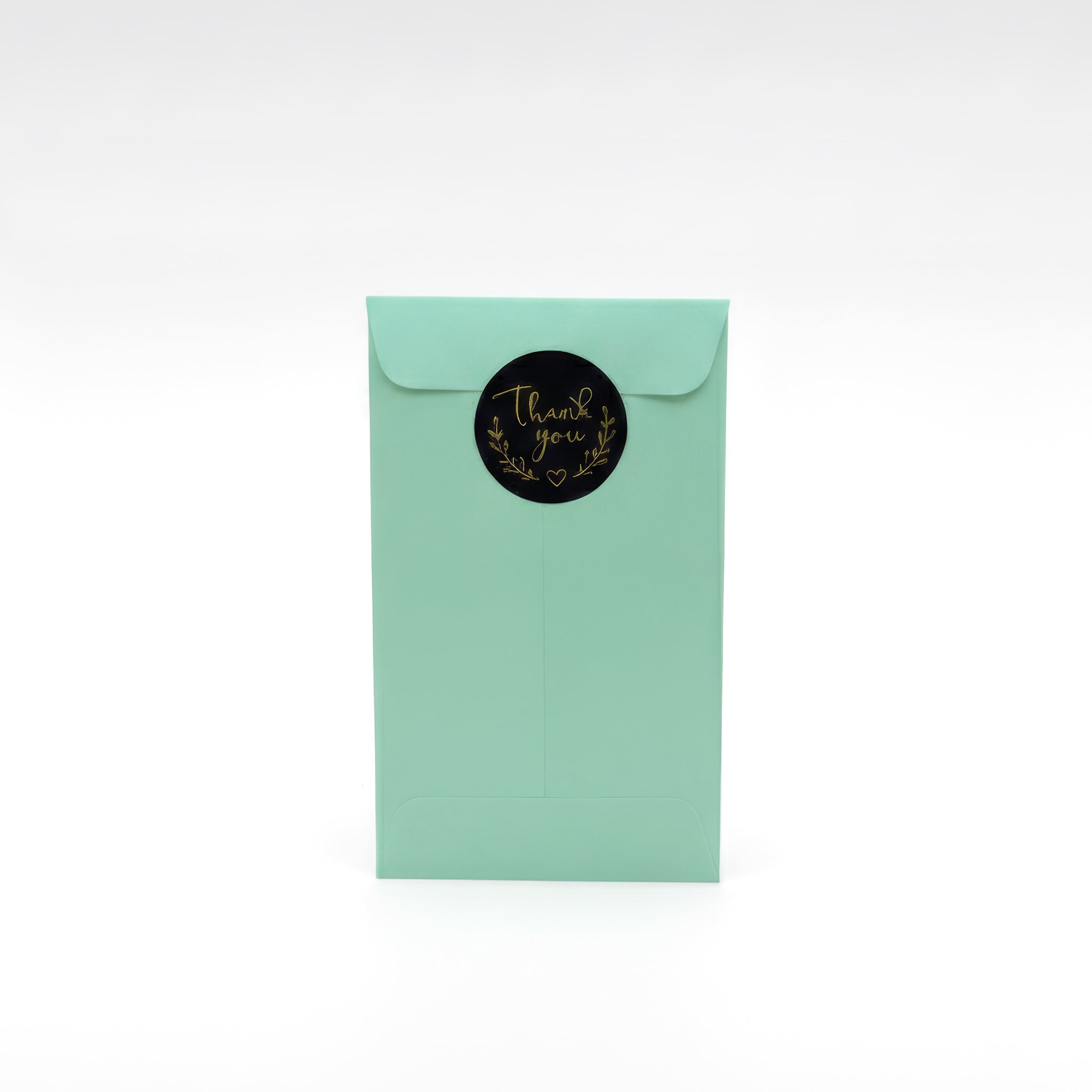 Mint green gift envelope with gold “Thank You” sticker — elegant packaging for personalised metal bookmark, handmade gift presentation UK.