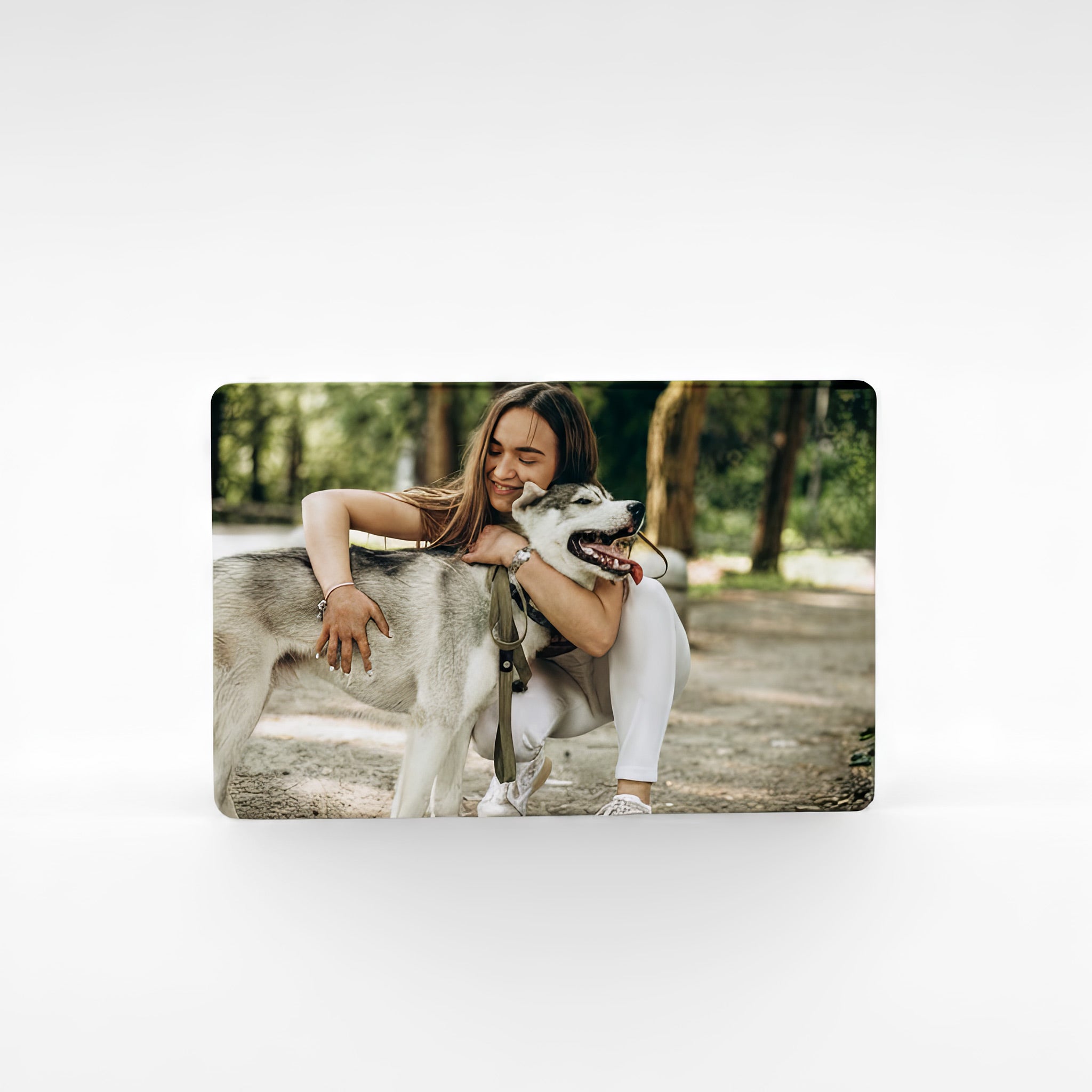 Custom metal photo wallet card with a woman and her dog, showcasing personalised pet photo printing on durable bank card sized aluminium.