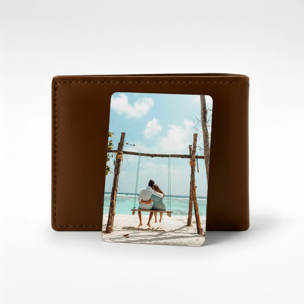 Personalised photo wallet card displayed against a brown leather wallet, featuring a couple on a beach swing — a perfect keepsake gift for preserving special memories.