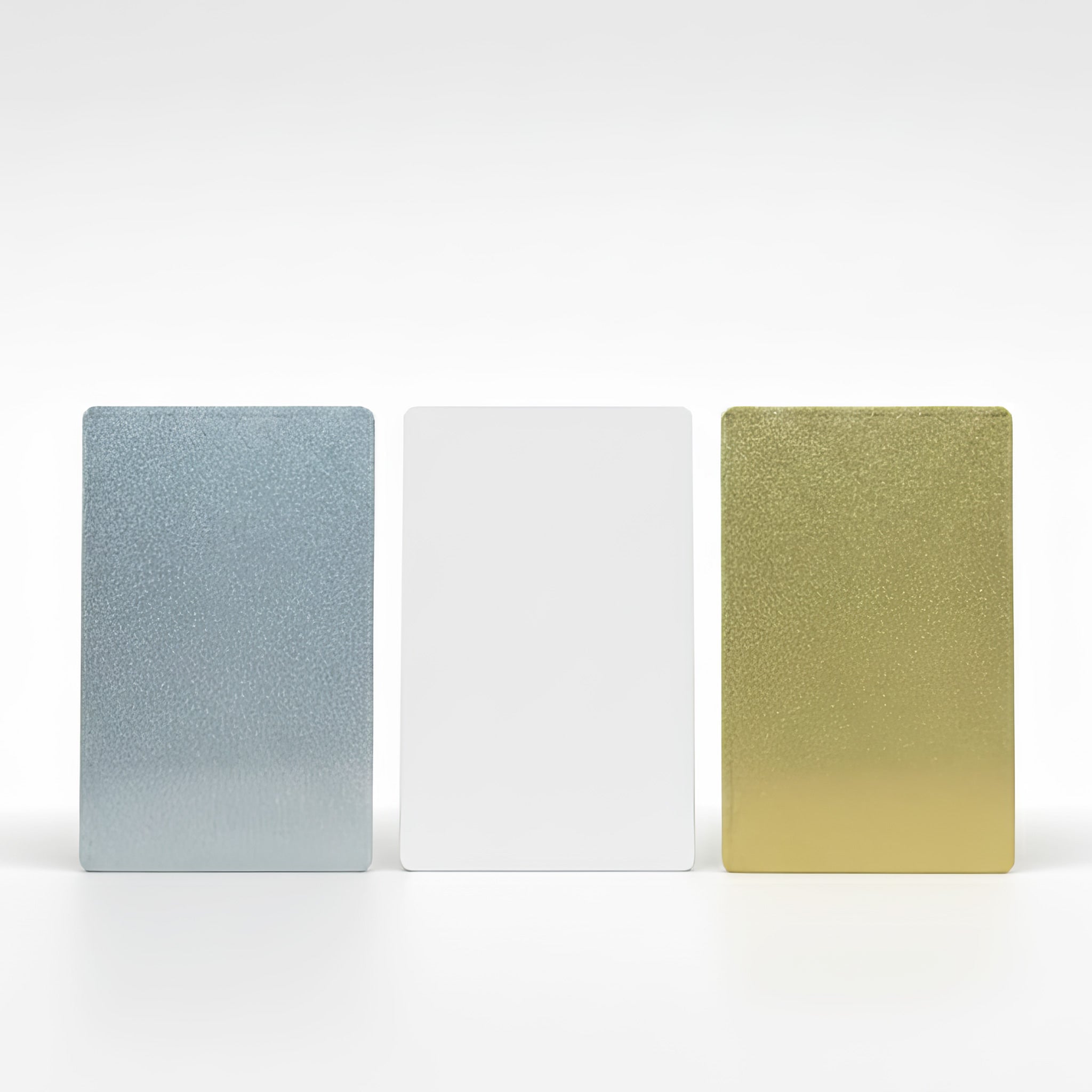 Set of three metal wallet cards in silver, white and gold finishes showing colour options for personalised photo printing of custom designs.