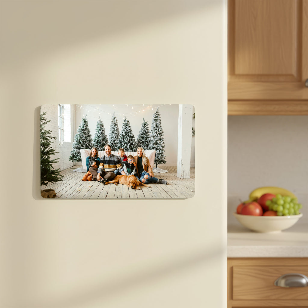 Custom family photo fridge magnet in landscape orientation featuring a Christmas portrait, attached to a kitchen fridge.
