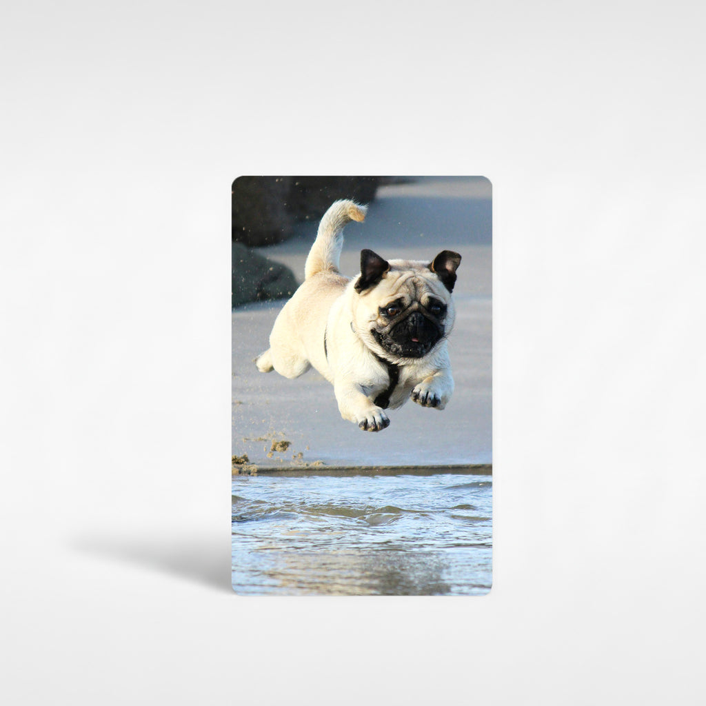 Custom pug fridge magnet featuring a playful pug running by the sea, personalised pug gift handmade in the UK
