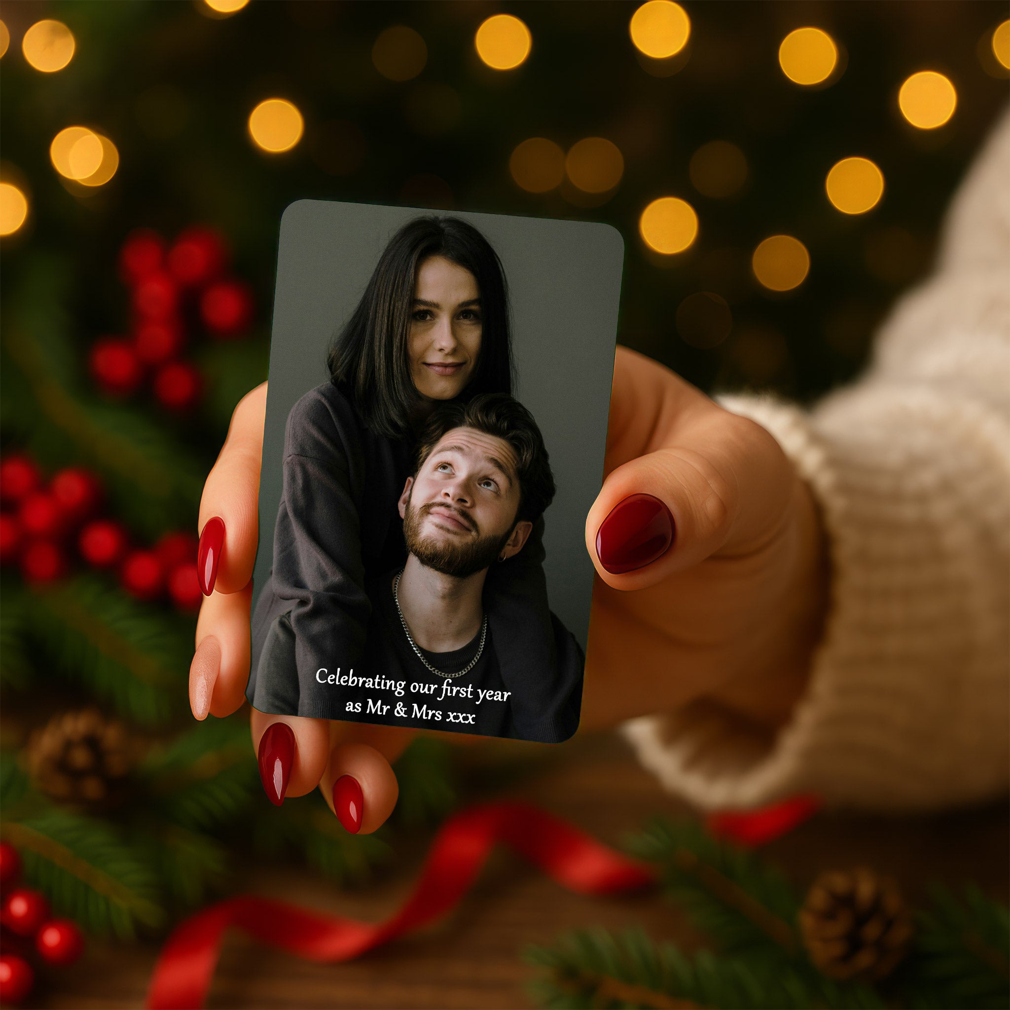 Woman holding personalised photo wallet card with festive background lights — meaningful Christmas gift for husband or boyfriend celebrating love and memories.