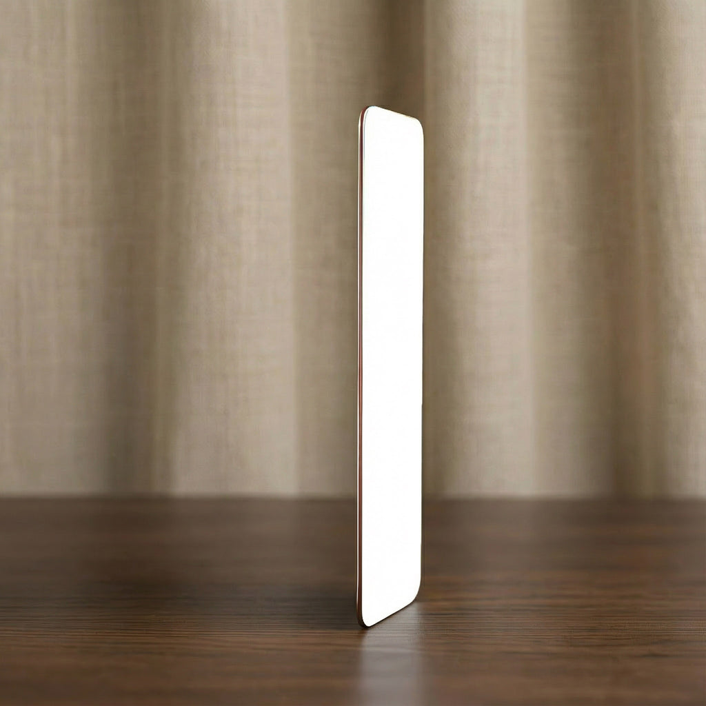 Side profile view of a metal wallet card showing the ultra-thin, durable aluminium construction and smooth rounded corners.